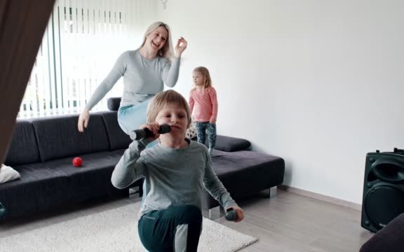 Children being active in living room with mum