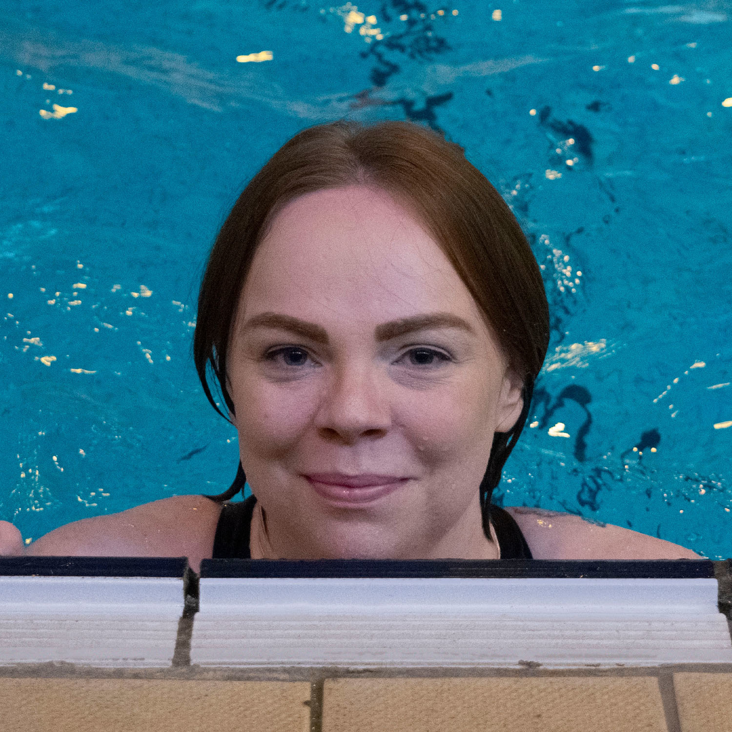 Smiling lady in swimming pool